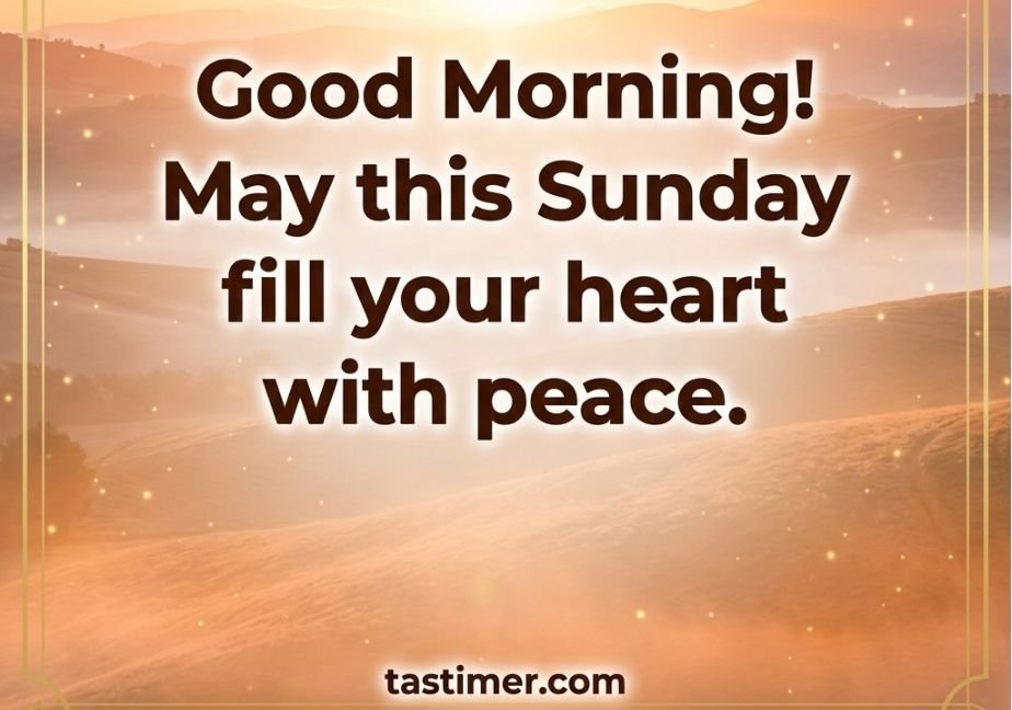 "A glowing golden sunrise over soft rolling hills with morning mist in the valleys, surrounded by a thin gold border with decorative corner flourishes. Centered in bold brown text is the message 'Good Morning! May this Sunday fill your heart with peace.' with 'tastimer.com' at the bottom center."